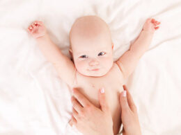 Mother massaging baby